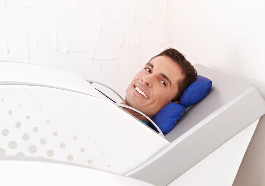 Patient relaxing inside a HOCATT ozone steam sauna chamber during a detox session