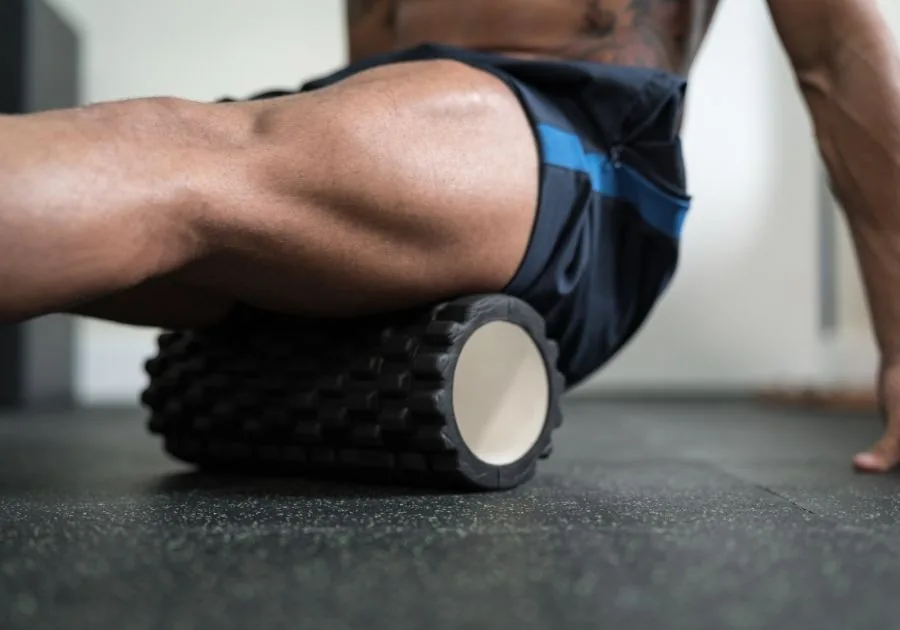 Athlete easing post-workout muscle soreness while exploring options for faster sports injury rehab